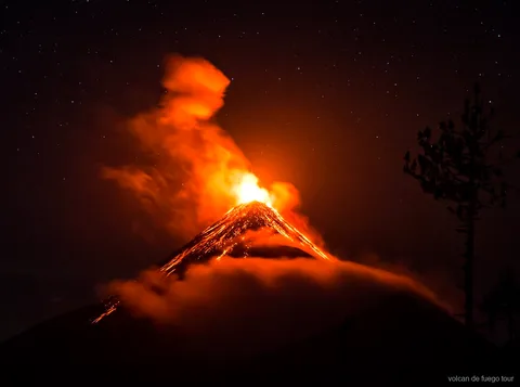 Base camp cabins on the Acatenango Fuego hike tour with Fuego volcano in view
